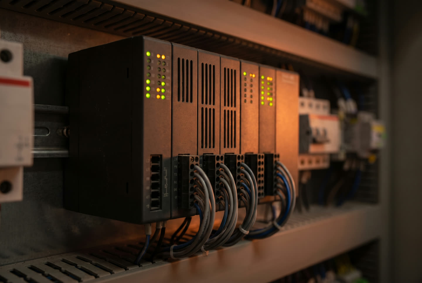 Programmable logic controller rack with status lights inside a control cabinet